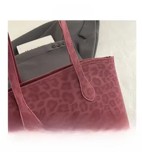 Close-up of burgundy leopard print tote bag with reinforced stitching details