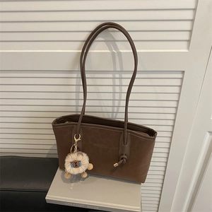 Large leopard print tote bag in dark brown with thin shoulder straps and bear charm