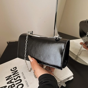 Classic black patent leather chain handbag with mim logo and metallic handle for women