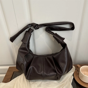 Deep brown pleated shoulder bag with knotted strap and lychee grain texture in retro style