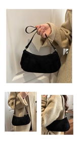 Detail shot of black frosted suede crescent shoulder bag with silver zipper and slim strap