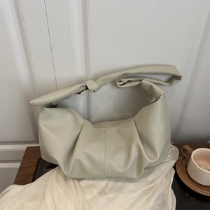 Minimalist beige hobo bag with pleated texture and wide knotted shoulder strap