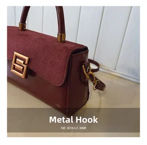 Detail of burgundy bag showing vintage gold hardware and textured suede flap