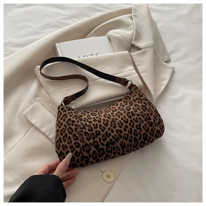 Close-up of leopard print shoulder bag with silver zipper and dark brown strap detailing