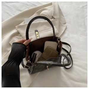 Detailed interior view of a monogram tote bag with spacious storage and gold hardware