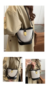 Close-up of a retro patchwork bucket bag featuring canvas, leather and a gold twist lock
