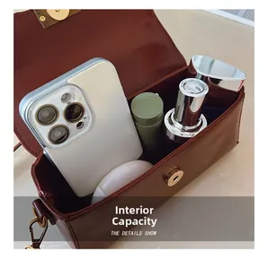 Internal view of a burgundy leather rectangular bag showing capacity for daily essentials