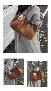 Detailed view of brown leopard print tote bag with leather strap and plush cat charm