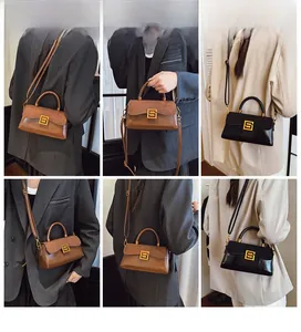 Detailed views of vintage crossbody bag showing dual-tone leather and gold metal clasp