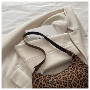 Close-up of leopard print shoulder bag with pony hair texture and silver metal hardware