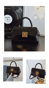 Macro detail of the elegant black handbag with golden G-buckle and contrast texture finish