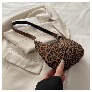 Detail of leopard print hobo bag with suede texture and dark shoulder strap