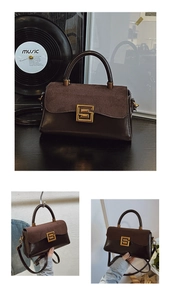 Detail of vintage square bag showing mixed textures, gold buckle and leather handle