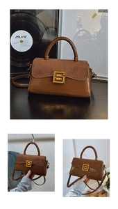 Close-up of vintage brown leather satchel with matte flap and square gold S-buckle
