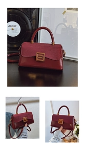 Close-up of wine red patchwork handbag featuring vintage metal buckle and leather textures