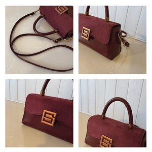 Detail of burgundy matte and leather crossbody bag with elegant gold metal buckle