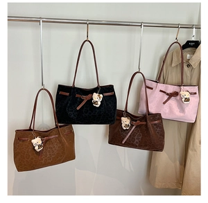 Detail of leopard print tote bags in four colors with buckle straps and plush charms