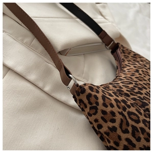 Close-up of leopard print hobo bag showing faux leather strap and silver metal hardware