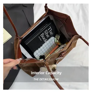 Top view of brown leather tote bag interior showing large capacity for iPad and books