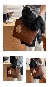 Brown woven leather tote bag with plush dog charm shown in an indoor office setting