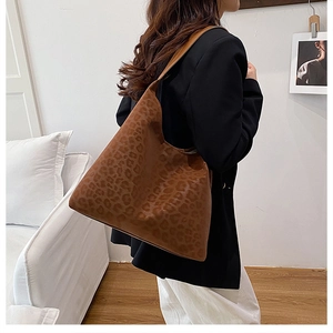 Detailed view of large brown leopard print tote bag with matte texture for daily commuting