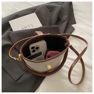 Top view of canvas bucket bag interior showing smartphone and makeup storage capacity