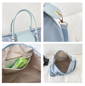 Detail view of large travel bag showing dry-wet separation pocket and smooth blue nylon fabric