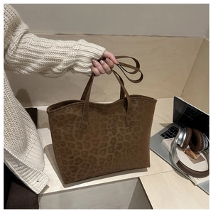 Macro detail of brown leopard print tote bag in premium matte suede fabric for office look