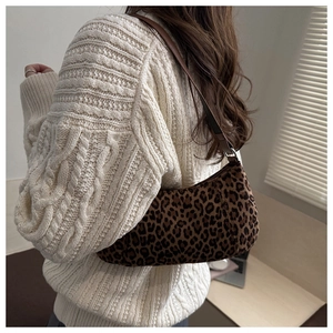 Detail of leopard print hobo bag with suede texture and brown leather shoulder strap