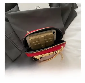 Interior view showing the capacity for a smartphone and wallet in a red evening clutch