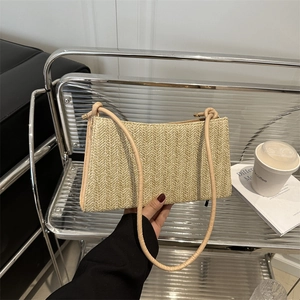 Chic beige straw shoulder bag with herringbone weave and premium leather straps