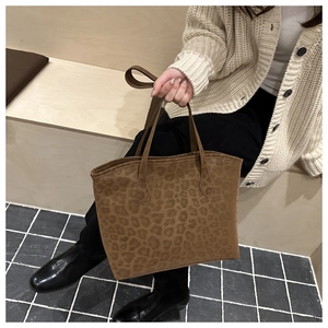 Detail of leopard print tote bag in soft suede material for vintage winter fashion