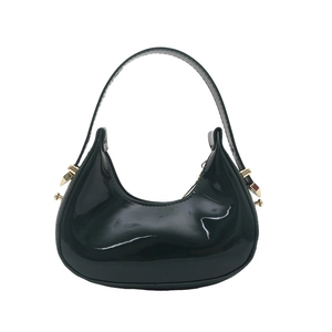 Glossy black patent leather crescent handbag with elegant gold buckle and sleek shoulder strap