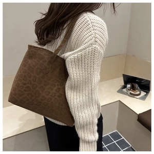 Detail of leopard print suede tote bag showing texture and casual shoulder carry style