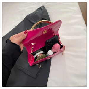 Internal detail view of the hot pink patent leather handbag showing storage capacity