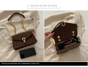 Macro detail of leopard print shoulder bag with gold horseshoe buckle and chain strap