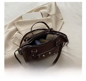 Interior storage of brown suede motorcycle bag with rivets showing spacious capacity