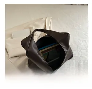 Spacious dark brown tote bag interior showing capacity for books and daily essentials