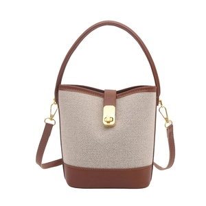 Retro canvas bucket bag with brown faux leather trim and golden metal turn-lock closure
