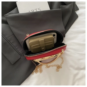Detail view of red leather crossbody bag interior showing phone and wallet storage space