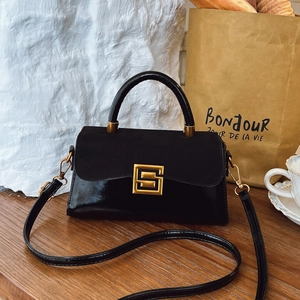 Vintage black matte crossbody bag with gold hardware and stylish top handle design