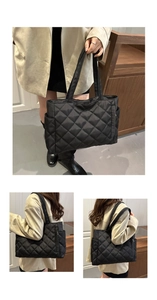 Detail of black quilted tote bag showing large capacity design and side pocket feature
