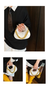 Detail view of a white mini hobo bag featuring a chunky gold chain strap and glossy finish