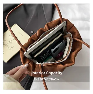 Spacious interior of brown suede tote bag showing tablet and phone storage