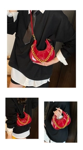 Detail of red patent leather dumpling bag featuring gold chain strap and moon-shaped texture