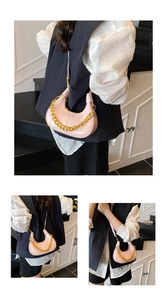 Detail view of pink hobo bag with a chunky gold chain strap and polished finish