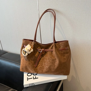 Vintage leopard print oversized tote bag with brown leather straps and plush charm