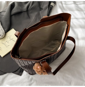 Top view of woven tote bag showing spacious interior with zipper pocket and bear charm
