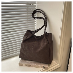 Detailed view of dark coffee tote bag with thick braided handles and suede texture