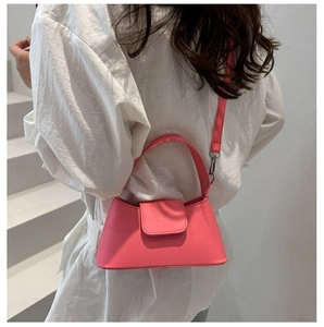 Close-up of pink faux leather bag featuring silver hardware and a stylish crossbody strap